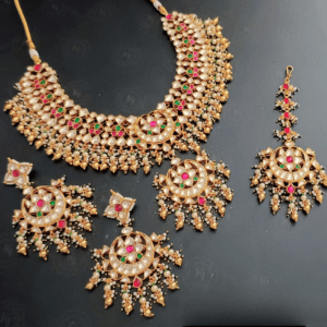 Arunima Pachi Kundan Set In Ruby/Green Colour With Golden Beads